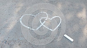 Couple heart drawn with chalk on the asphalt. love confession. banner place for text, valentine, children creativity copy space,