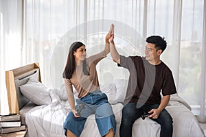 Couple high-five or clap hands while play game