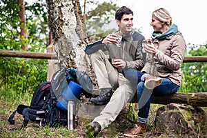 Couple on hike taking rest under tree