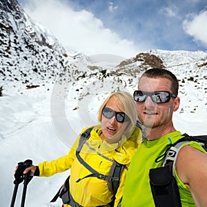 Couple hikers selfie portrait expedition in winter mountains