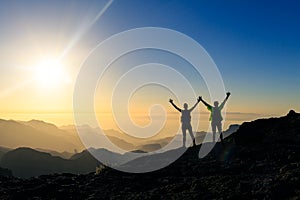 Couple hikers success and trust concept in mountains