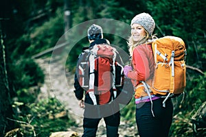 Couple hikers walking in mountains