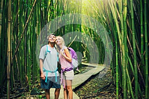 Couple hiking through bamboo forest