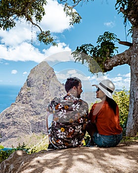 Couple hiking in the mountains Saint Lucia Caribbean, nature trail in the jungle of Saint Lucia with a look at the huge