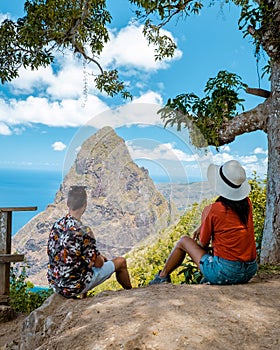 couple hiking in mountains Saint Lucia Caribbean, nature trail in jungle with view of huge Pitons