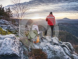 Couple hiking photographers on view point above forest