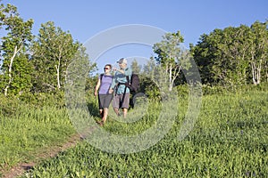 Couple hiking together on a mountain trail