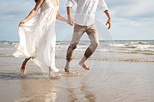 Couple hold hands on beach. Romantic couple on the beach