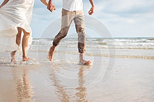 Couple hold hands on beach. Romantic couple on the beach