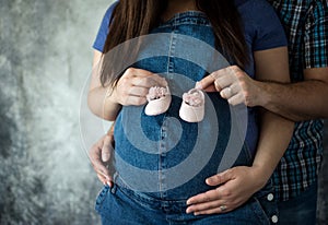 Couple Holding belly and little shoes