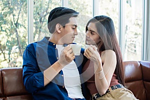 Couple is holding cups of coffee