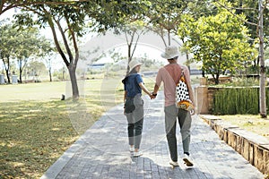 Couple holding each othe hand walking at park