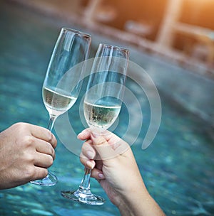 Couple holding glasses of champagne making a toast