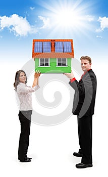 Couple holding green house