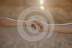 A couple holding hand at the beach, Algarve, Portugal