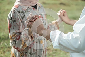 A couple holding hand with Nature greenfield Background