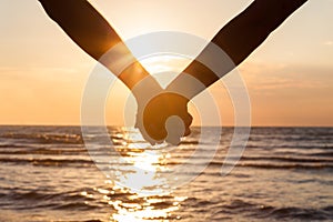 Couple holding hands at beach