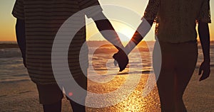 Couple holding hands, beach at sunset and sea with back view, vacation and travel with man and woman outdoor. Love