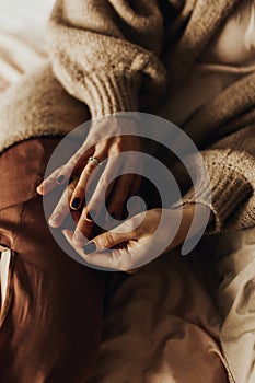 Couple holding hands in bed. hand with engagement ring. Couple in love. Love concept.