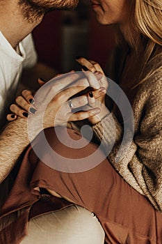 Couple holding hands in bed. hand with engagement ring. Couple in love. Love concept.