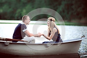 Couple holding hands in boat