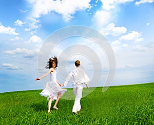 Couple holding hands in a field