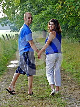 Couple holding hands looking back