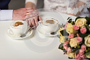 Couple holding hands, loving couple drinking coffee in a coffee