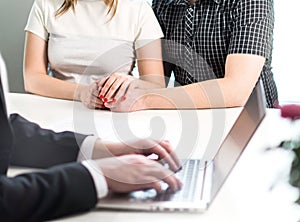 Couple holding hands in meeting with professional man.