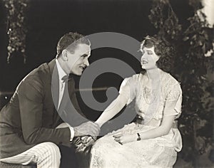 Couple holding hands in park