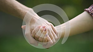 Couple holding hands in the Park. Hold on, hands, couples. Couple hold hand in the autumn or summer park. Closeup of