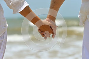 Couple holding hands together