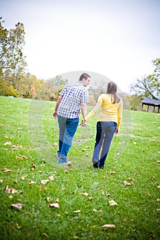 Couple Holding Hands Walking in a Field