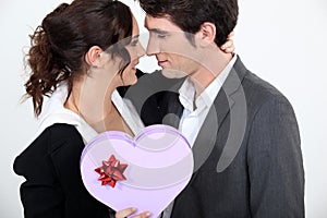 Couple holding heart-shaped box