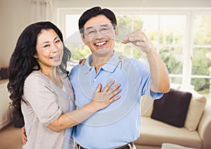 Couple Holding key in sitting room