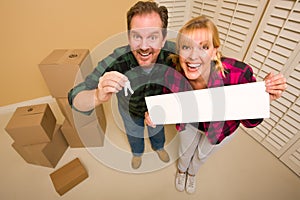Couple Holding Keys and Blank Sign with Boxes
