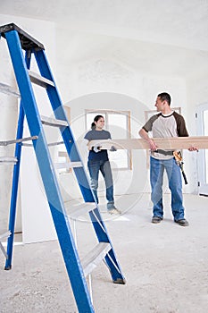 A couple holding a plank of wood photo