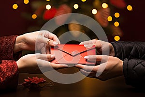 a couple holding a red envelope with christmas tree
