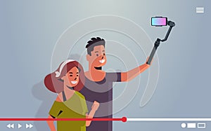 Couple holding stabilizer with cellphone man woman taking selfie photo on smartphone camera live video streaming