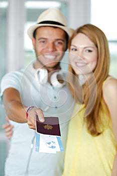 Couple holding travel tickets and passport