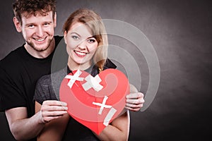 Couple holds broken heart joined in one