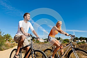 Couple in holidays cycling