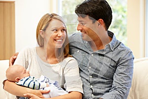 Couple at home with new baby