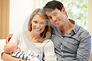 Couple at home with new baby