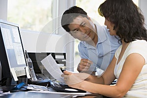 Couple in home office with computer and paperwork