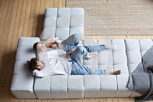 Couple at home relaxing in sofa top view. Domestic life