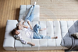Couple at home relaxing in sofa top view. Domestic life