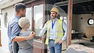 Couple, home rennovation and construction builder shaking hands for congratulations on new house, real estate purchase