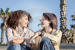 Couple of homosexual women talking sitting