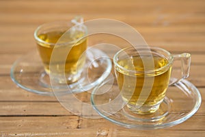 Couple hot chinese tea in glass with wood background